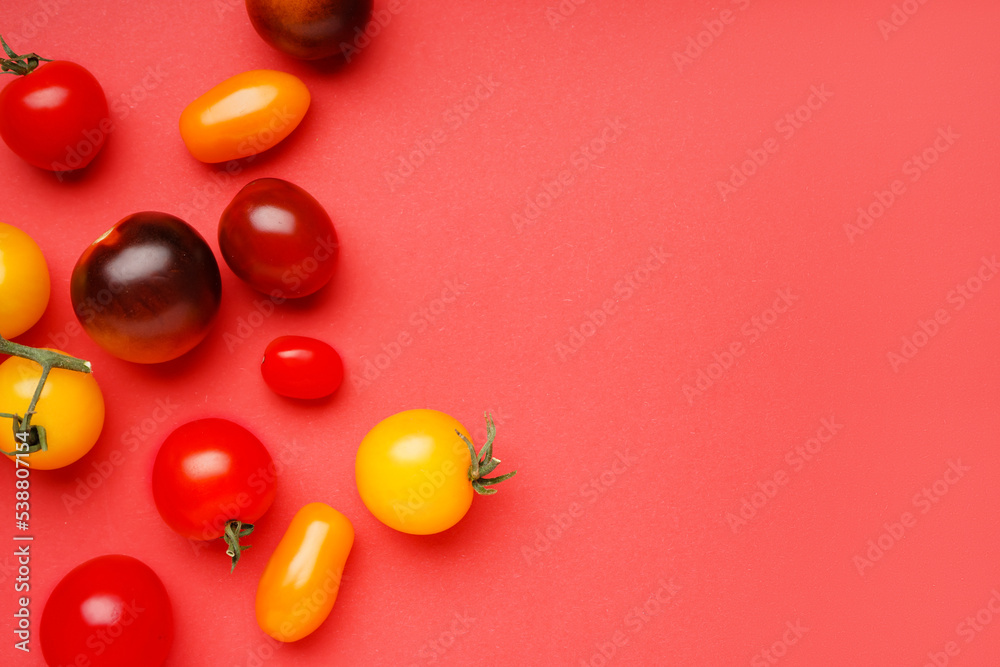 Different fresh tomatoes on red background