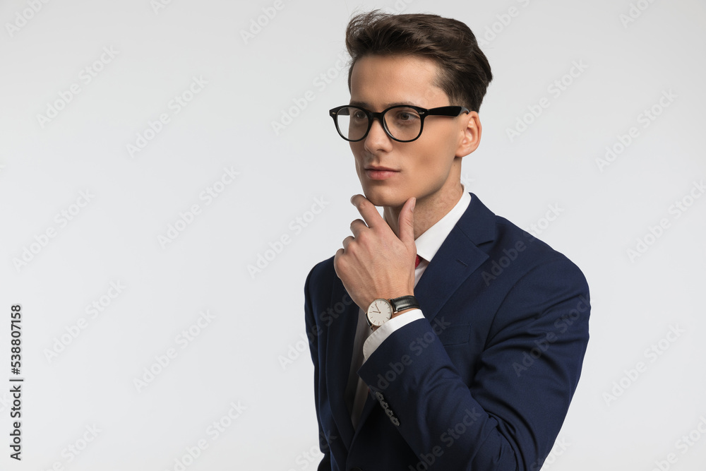 thoughtful businessman holding hand to chin and thinking thoughtful businessman holding hand to chin and thinking