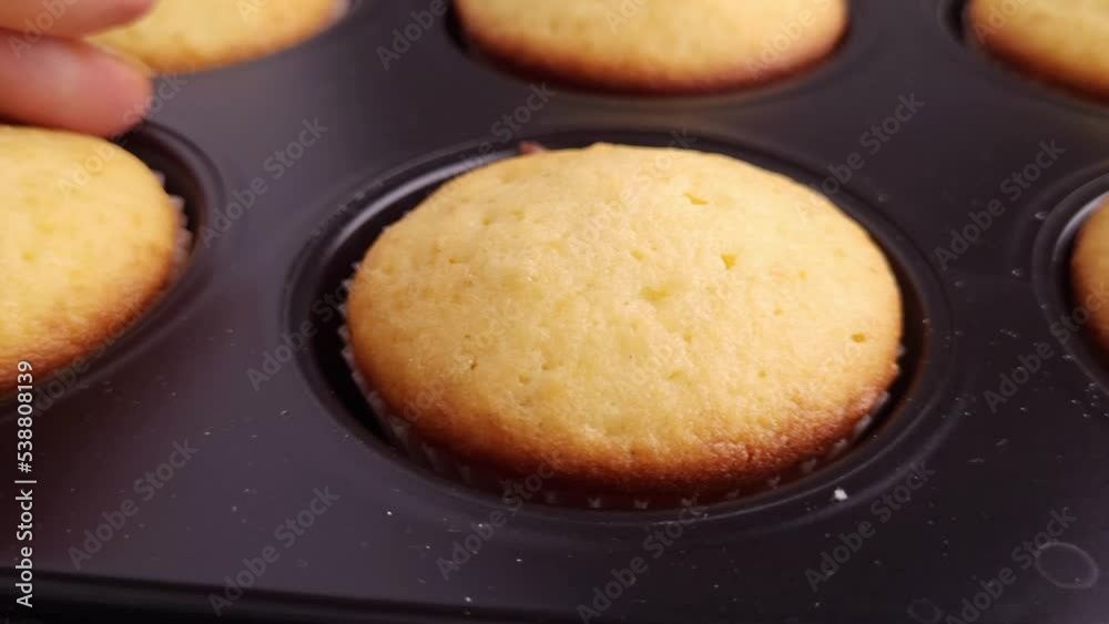 Freshly baked muffins in the form close-up, smooth motion Freshly baked muffins in the form close-up, smooth motion