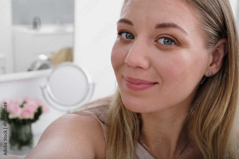 Young amazing happy pretty lady. woman blogger is showing how to make up and use cosmetics. In front of the camera to recording vlog video live streaming at home Young amazing happy pretty lady. woman blogger is showing how to make up and use cosmetics. In front of the camera to recording vlog video live streaming at home