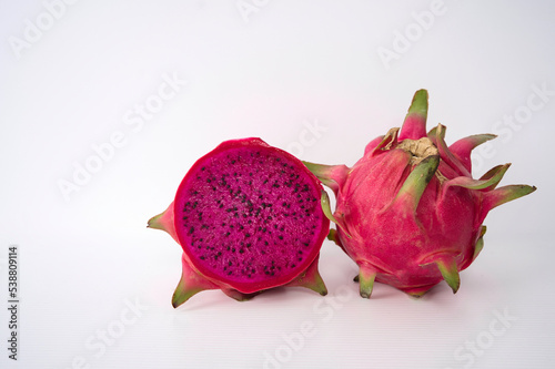 A whole fruit and halved of the Pitaya or Dragon Fruits, isolated