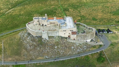 Orbital aerial shot of the castle at Lindisfarne in North East of England. The castle is very interesting as it is built directly onto a stone mound and has recently been substantially refurbished. photo