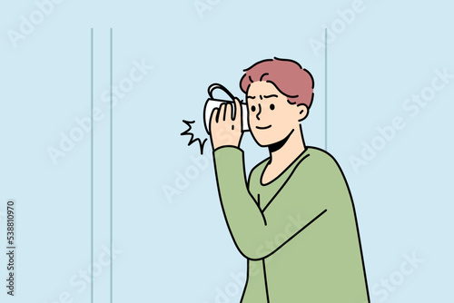 Boy listens to what is happening behind wall with mug near his ear. Guy wants to know secrets, mysteries of his neighbors. Teenager finds out why his parents are arguing. Vector outline illustration.