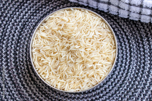 Basmati rice inside bowl, raw basmti long grain rice top close up view