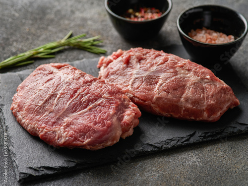 Foto Raw fresh pork cheeks with salt and pepper