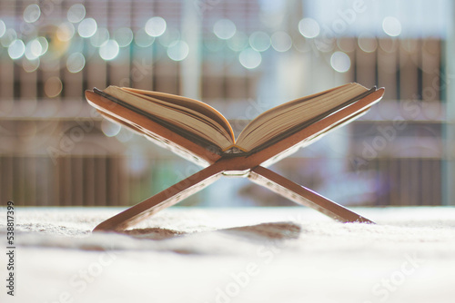 quran put on a wooden board quran is a book Muslim religious principles, background photo