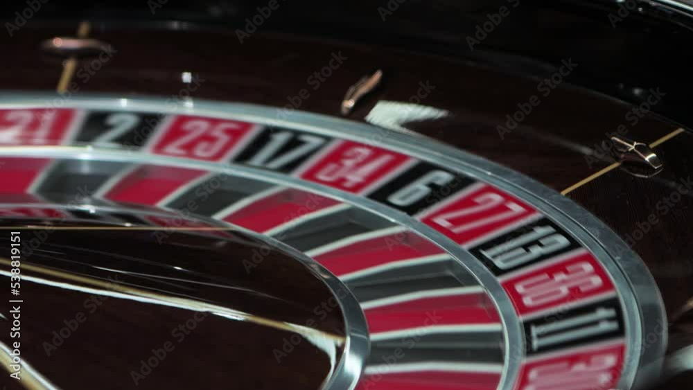 Dealer starts roulette wheel clockwise spin. Ball rotates counterclockwise inside drum. European Casino. Ball falls on black number 24. Gambling ludopathy. Fortune risk chance. Lucky nightlife Closeup Dealer starts roulette wheel clockwise spin. Ball rotates counterclockwise inside drum. European Casino. Ball falls on black number 24. Gambling ludopathy. Fortune risk chance. Lucky nightlife Closeup