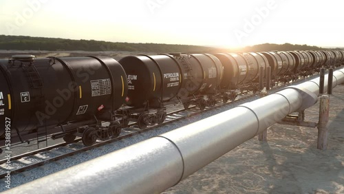 Natural gas transportation via gas main pipeline and fuel petroleum delivering in the oil cistern on the railroad. Freight train wagons with crude oil and tube pipeline fullish with gas, 3d render. photo