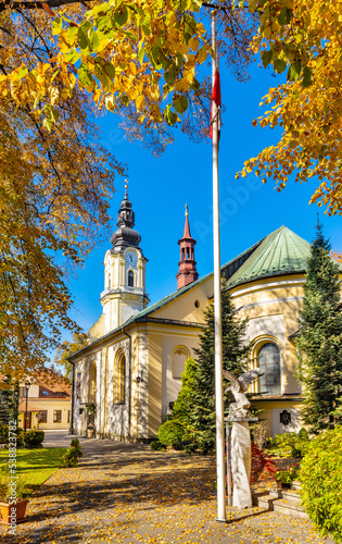 St. Matthias church, kosciol sw. Macieja, under autumn colors in historic old town quarter of Andrychow in Poland photo