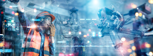 Wallpaper Mural Engineer Woman checking and controlling automation robot arms machine in intelligent factory industrial on interface, Maintenance and quality control, Digital manufacturing operation. Torontodigital.ca