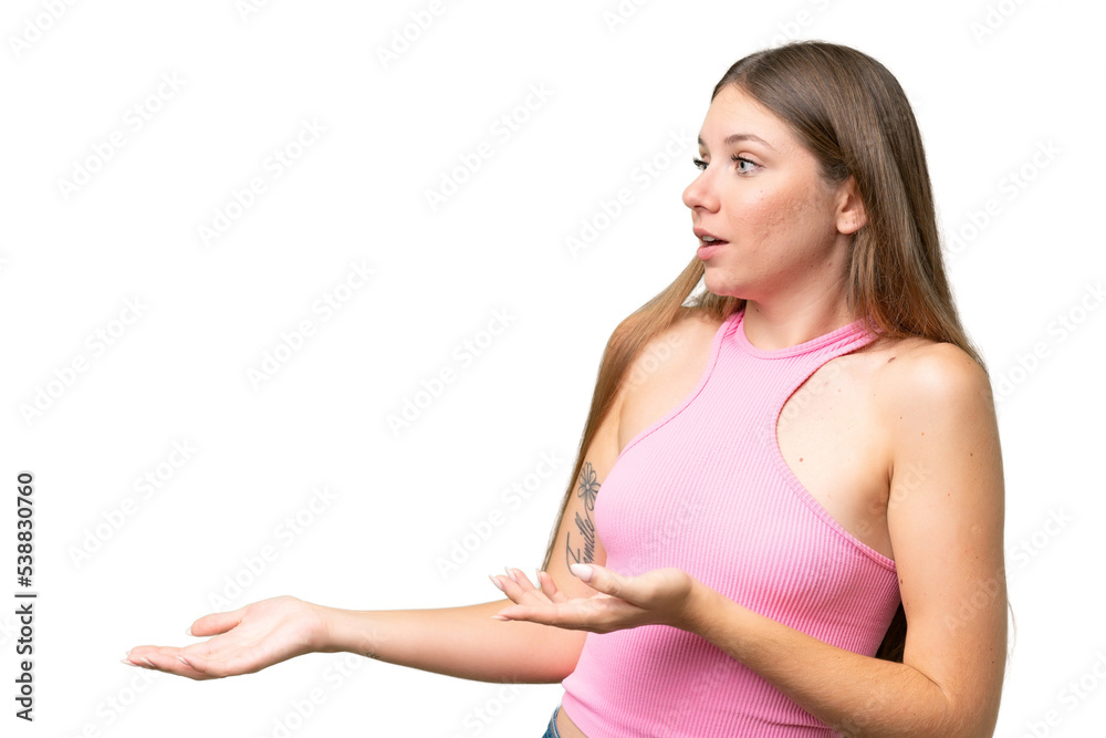 Young beautiful blonde woman over isolated background with surprise expression while looking side Young beautiful blonde woman over isolated background with surprise expression while looking side