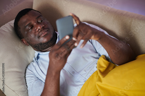 Man Checking Social Media on Smartphone