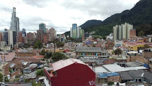 Colombia, Bogota'2022  - Drone aerial view of Candelaria old historic Spanish colonial district and the modern skyline in downtown of the city with skyscrapers - view from Plaza del Chorro de Quevedo  photo