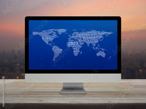 2023 start up business icon with words world map on computer screen on wooden table over cityscape on warm light sundown, Happy new year 2023 start up online, Elements of this image furnished by NASA