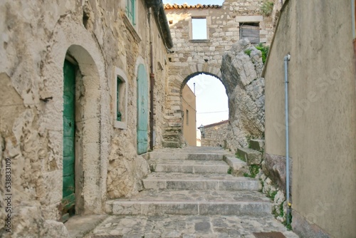 A narrow street between the old stone houses of Bagnoli del Trigno  a medieval village in the Molise region of Italy.