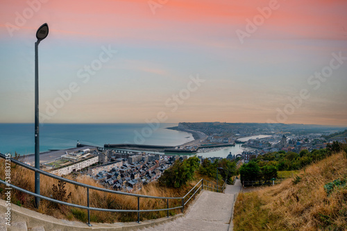 France, Normandy, Le Treport, Hillside staircase with coastal town in background photo