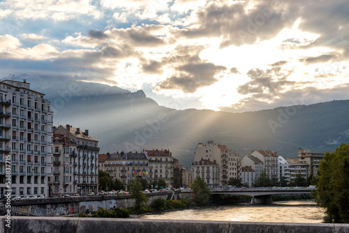 sunset over the city with clear ear sun rails in Grenoble