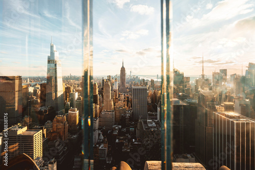 USA, New York, New York City, Midtown Manhattan at sunset seen through window photo