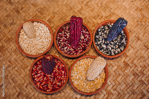 Bowls with different varieties of corn grains photo