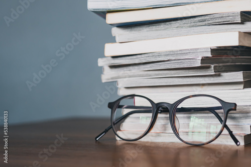Eyeglasses and a stack of books