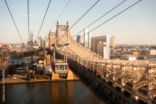 USA, New York, New York City, Overhead Cable Car moving along Queensboro Bridge at dusk photo