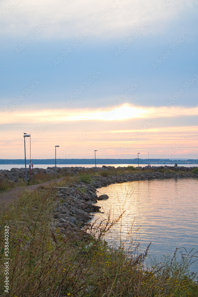 Sunset in Sweden at the harbor of lake Vaettern. Landscape shot in Scandinavia.