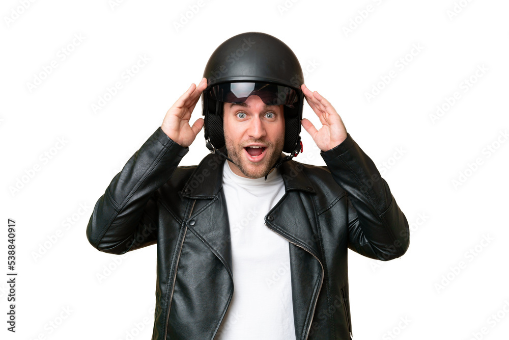 Young caucasian man with a motorcycle helmet isolated on green chroma background with surprise expression Young caucasian man with a motorcycle helmet isolated on green chroma background with surprise expression