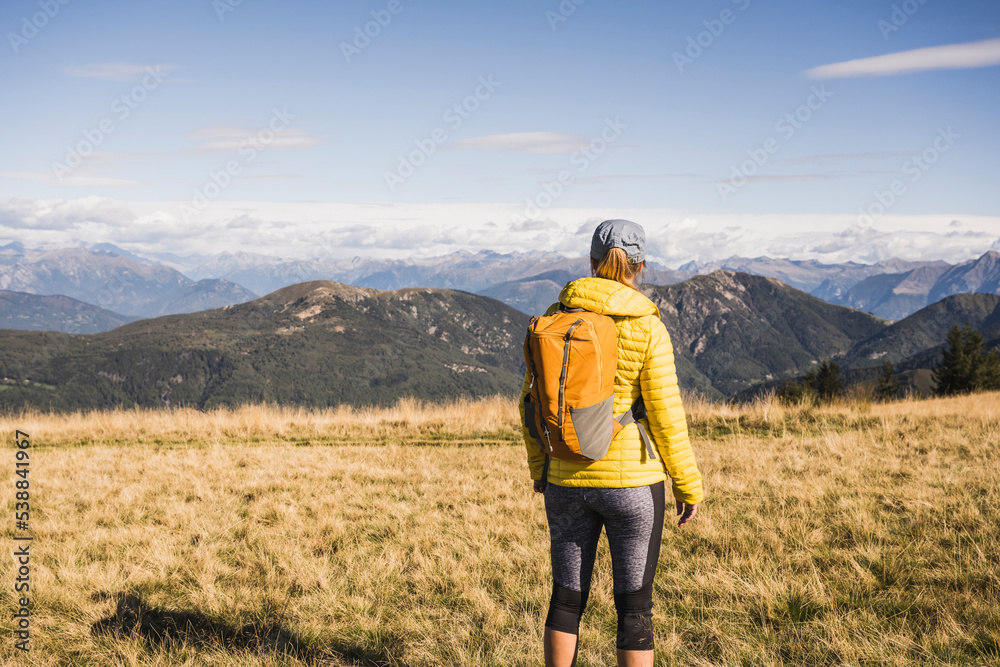 Mature woman looking at mountains on sunny day Mature woman looking at mountains on sunny day