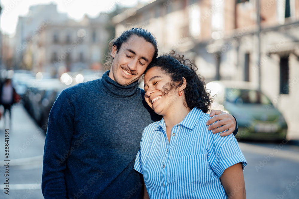 Smiling couple day dreaming together with eyes closed on street Smiling couple day dreaming together with eyes closed on street