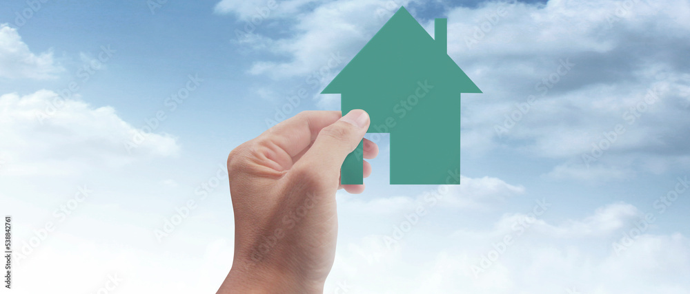 Naklejka premium Hands holding paper house, family home