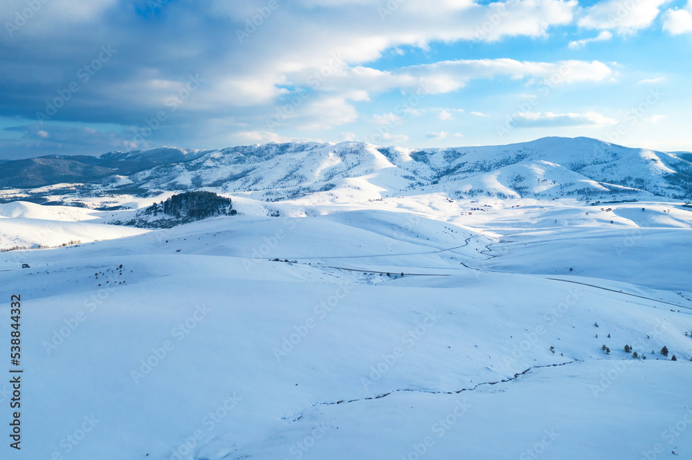 Aerial shot of beautiful snow capped mountains and hills winter landscape of Zlatibor, famous travel destination in Serbia
