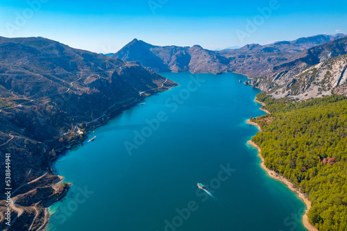 Green Canyon Turkey with travel ship, Manavgat Mountain Lake Aerial top view