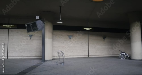 No people on the empty platfor of Kobenhavns Lufthavn, Kastrup train station of the Copenhagen Airport Denmark - wheelchair and supermarket car