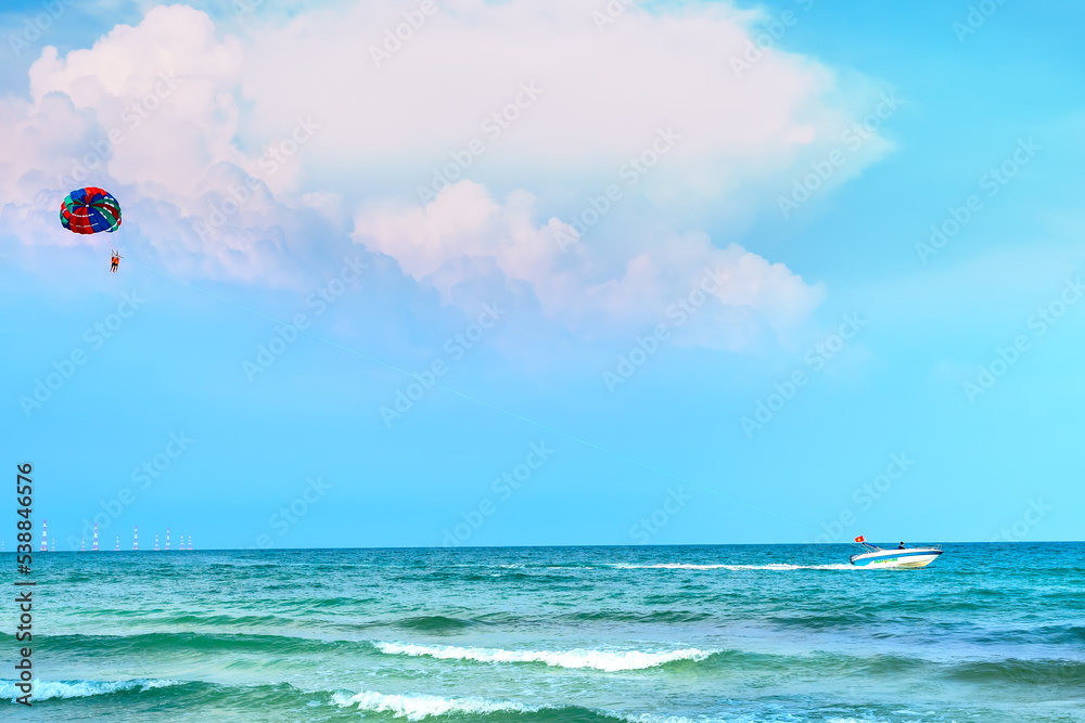 Beautiful tropical beach on the pearl island of Phu Quoc, Vietnam. The beach is clean, clear and blue, with fine sand stretching to attract tourists to have fun at the weekend Beautiful tropical beach on the pearl island of Phu Quoc, Vietnam. The beach is clean, clear and blue, with fine sand stretching to attract tourists to have fun at the weekend