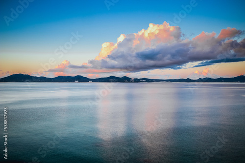 Early sunrise In August, Japan, Okinawa, Nago Clouds are reflected in the surface of the sea