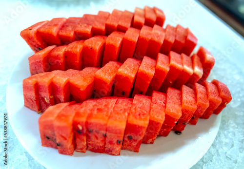 Sliced watermelon on a plate at the buffet. Fruits with lots of water and vitamins are good for human health