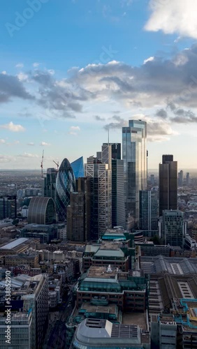 Vertical time lapse view of the modern skysrcapers at the City of London during a sunny day, United Kingdom photo