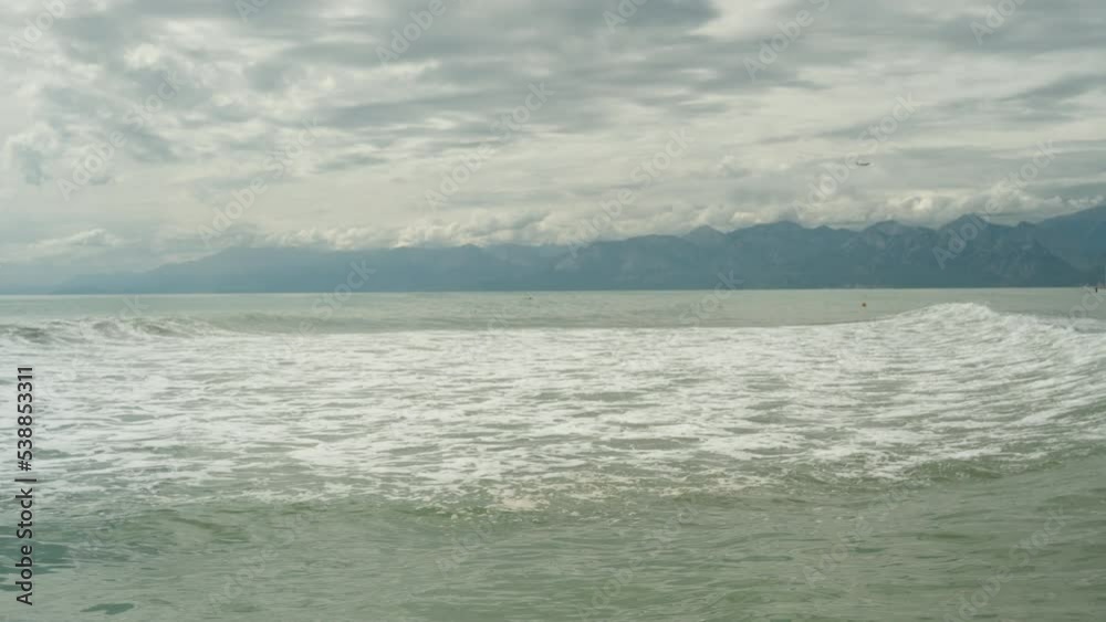 Stormy sea after a storm and thunderclouds against the background of mountains. Stormy sea after a storm and thunderclouds against the background of mountains.