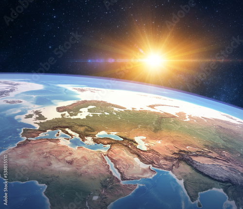 Fototapeta Naklejka Na Ścianę i Meble -  High angle satellite view of Planet Earth, focused on Europe, East Asia and North Africa, sun shining in outer space. 3D illustration - Elements of this image furnished by NASA