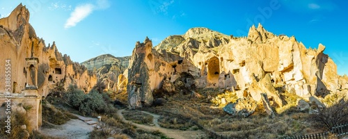 Wide panoramic background image of Zelve open air museum surroundings and fairy chimneys with no people. Cappadocia.Turkey photo