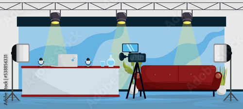 Vector illustration of modern interior TV studios. Cartoon interior with host table, sofa for guests, camera, lighting, microphone, background.