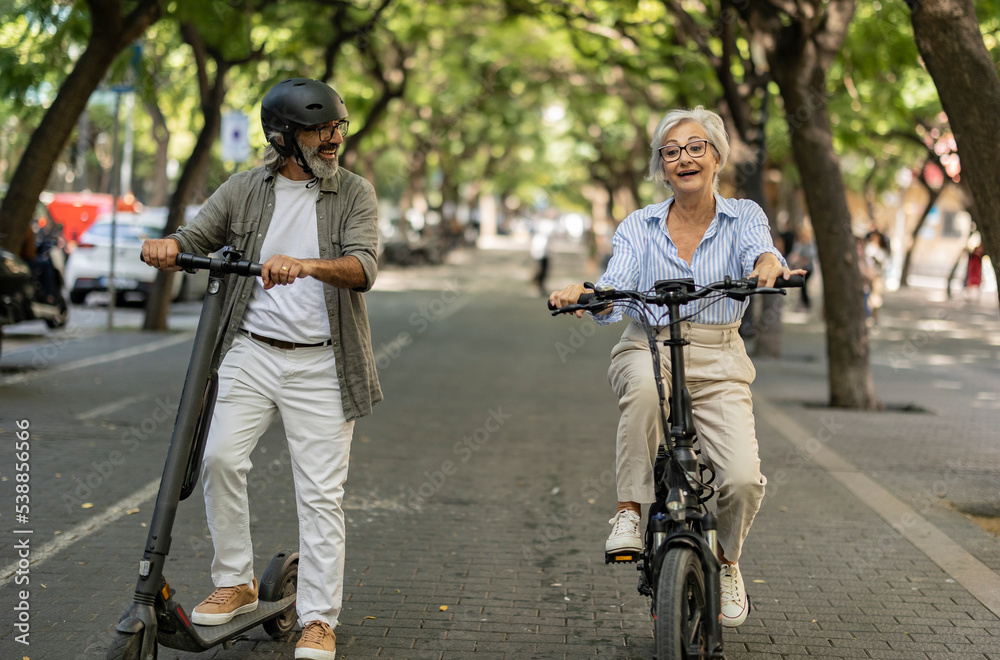 senior tourists riding electric bikes and electric scooters around town