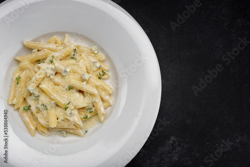 Pasta with parmesan and herbs on a plate