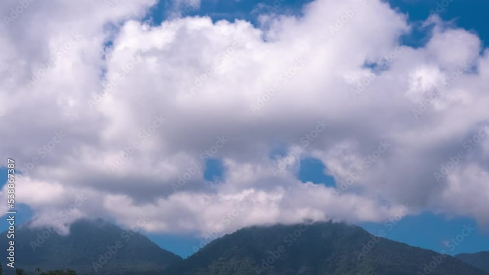 White clouds in blue sky above mountains, timelapse. Climate, weather, fresh air concept White clouds in blue sky above mountains, timelapse. Climate, weather, fresh air concept