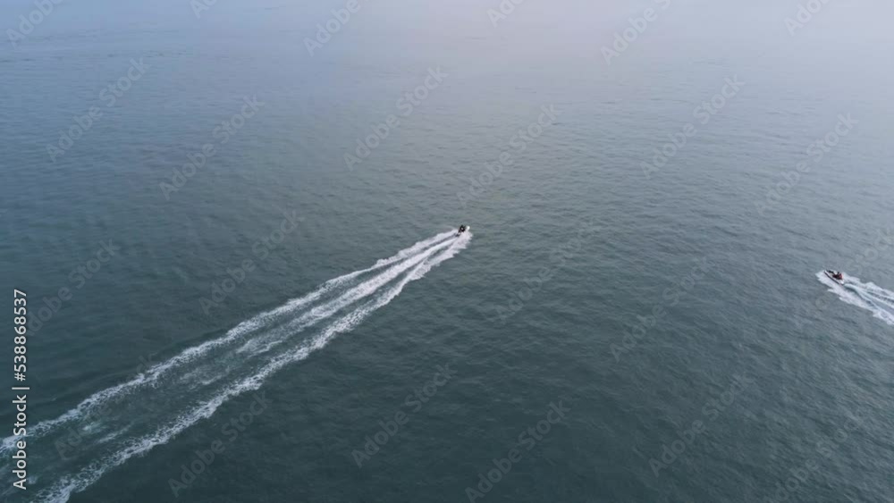 Jet ski riding on the surface of sea. Aerial view, drone shot. Travel vacation, water sports, active leisure concept Jet ski riding on the surface of sea. Aerial view, drone shot. Travel vacation, water sports, active leisure concept