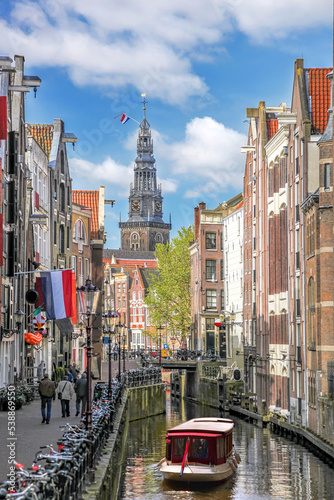 Traditional old buildings and houseboat on canal in Amsterdam, Netherlands