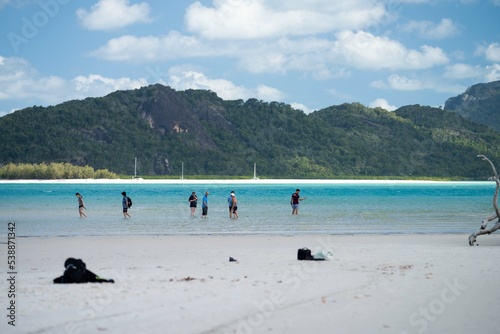 tourist taking a photo on a phone while on holiday. addicted to technology Tourism at the great barrier reef. 