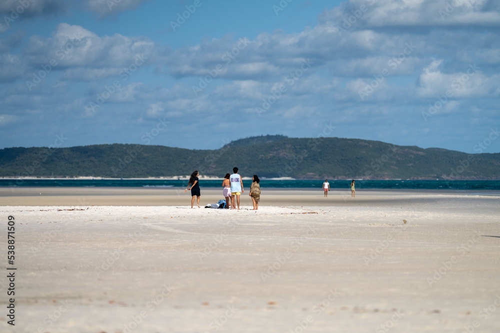 tourists and boats, on the beach at the great barrier reef in the Whitsundays in queensland Australia  