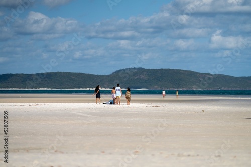 tourists and boats, on the beach at the great barrier reef in the Whitsundays in queensland Australia 