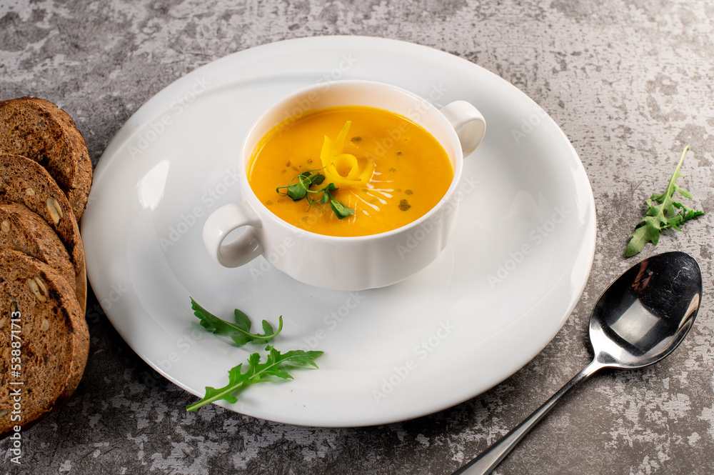 Fresh and healthy pumpkin cream soup with herbs. Vegan cuisine Fresh and healthy pumpkin cream soup with herbs. Vegan cuisine
